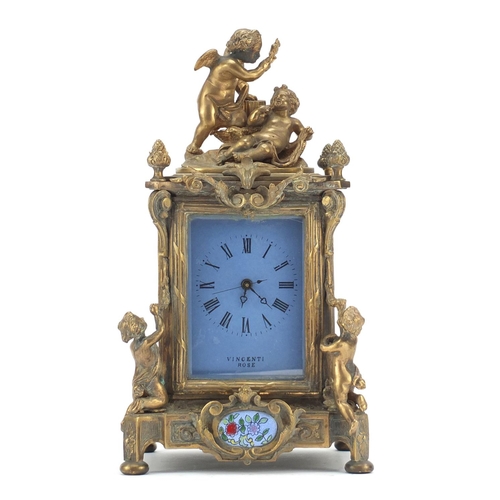 611 - Continental bronze mantel clock with porcelain panels mounted with cherubs. 30cm high