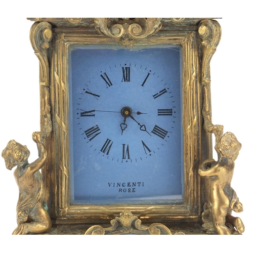 611 - Continental bronze mantel clock with porcelain panels mounted with cherubs. 30cm high