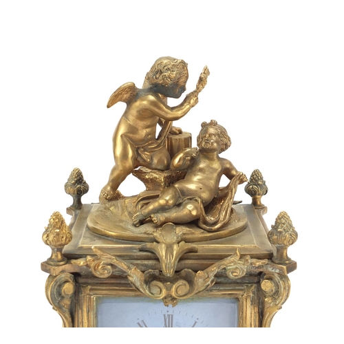 611 - Continental bronze mantel clock with porcelain panels mounted with cherubs. 30cm high