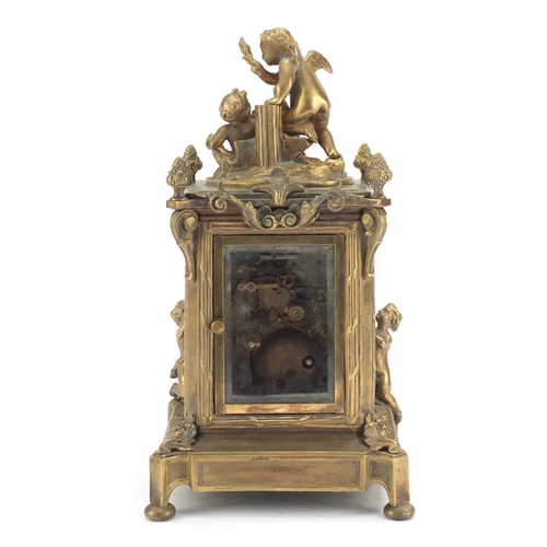 611 - Continental bronze mantel clock with porcelain panels mounted with cherubs. 30cm high