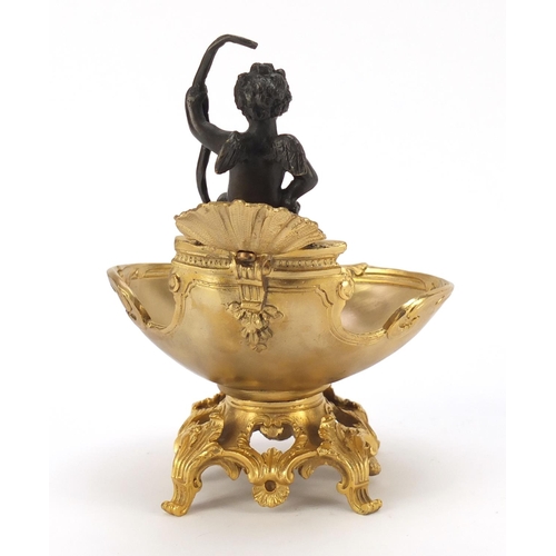 289 - Partially gilt bronze sweetmeat dish in the form of Putti seated on a shell above a bowl, impressed ... 