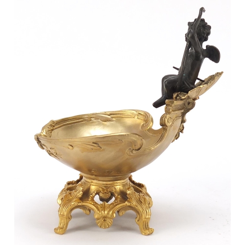 289 - Partially gilt bronze sweetmeat dish in the form of Putti seated on a shell above a bowl, impressed ... 