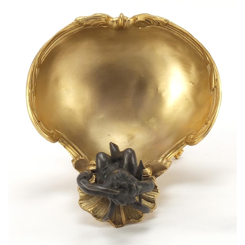 289 - Partially gilt bronze sweetmeat dish in the form of Putti seated on a shell above a bowl, impressed ... 