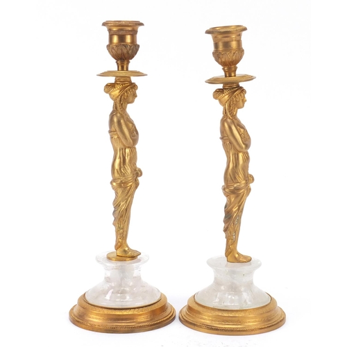 114 - Pair of French Empire style Egyptian revival gilt bronze and rock crystal candlesticks, each 25cm hi... 