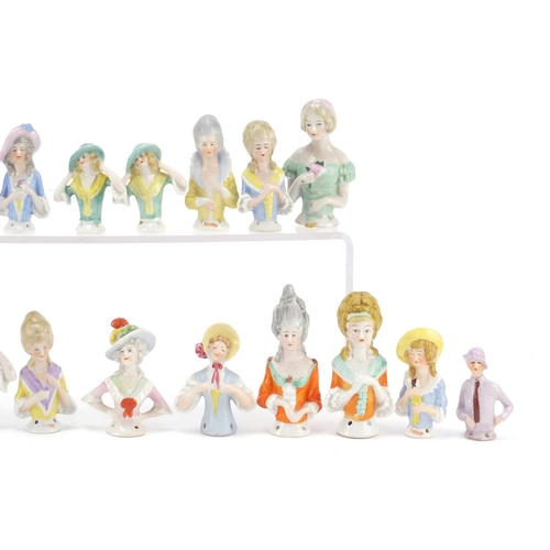 472 - Twenty two Victorian and later hand painted porcelain half pin dolls, the largest 10cm high