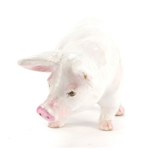 126 - White glazed pottery pig, possibly Scottish, indistinctly inscribed to one foot, 18.5cm in length