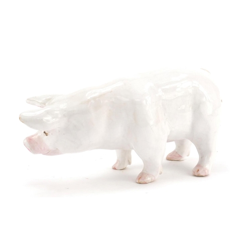 126 - White glazed pottery pig, possibly Scottish, indistinctly inscribed to one foot, 18.5cm in length