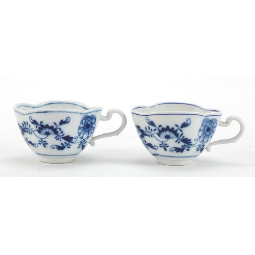 91 - Five Meissen demitasse cups and four saucers, each hand painted in the Blue Onion pattern, crossed s... 