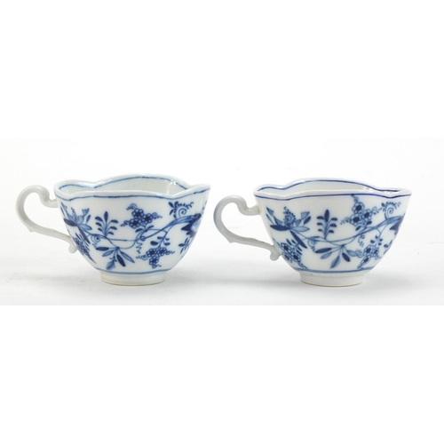 91 - Five Meissen demitasse cups and four saucers, each hand painted in the Blue Onion pattern, crossed s... 