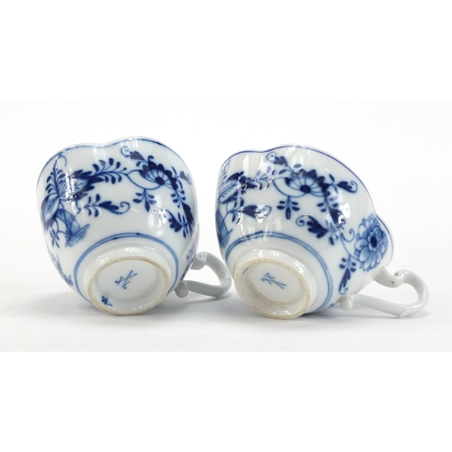 91 - Five Meissen demitasse cups and four saucers, each hand painted in the Blue Onion pattern, crossed s... 