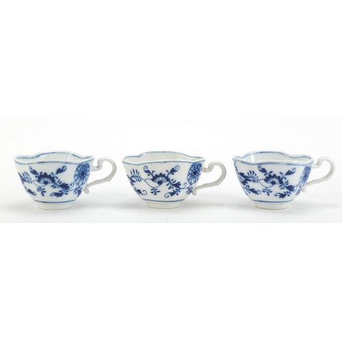 91 - Five Meissen demitasse cups and four saucers, each hand painted in the Blue Onion pattern, crossed s... 