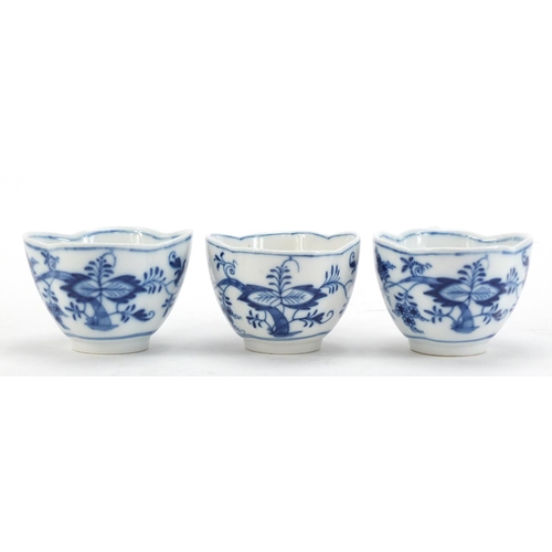 91 - Five Meissen demitasse cups and four saucers, each hand painted in the Blue Onion pattern, crossed s... 