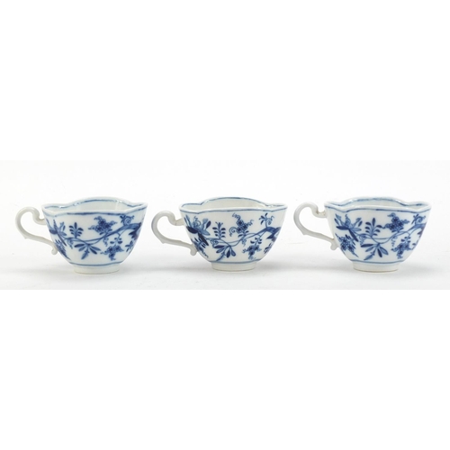 91 - Five Meissen demitasse cups and four saucers, each hand painted in the Blue Onion pattern, crossed s... 