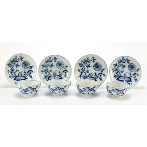 92 - Four Meissen cups and saucers hand painted in the blue onion pattern, crossed sword marks to the bas... 