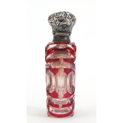 282 - Victorian ruby flashed cut glass scent bottle with unmarked silver hinged lid, 9.5cm high