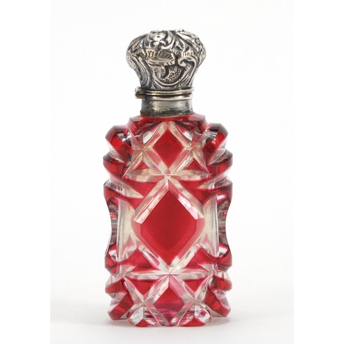 282 - Victorian ruby flashed cut glass scent bottle with unmarked silver hinged lid, 9.5cm high