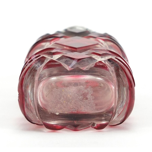 282 - Victorian ruby flashed cut glass scent bottle with unmarked silver hinged lid, 9.5cm high