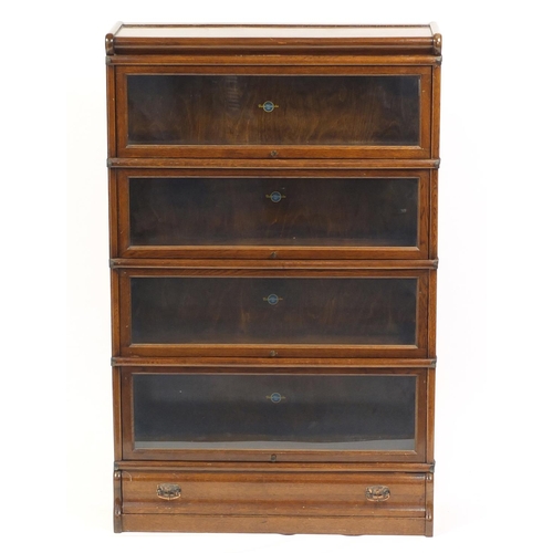 2063 - Oak Globe-Wernicke, four tier bookcase with drawer to the base, 135cm H x 87cm x 26cm D