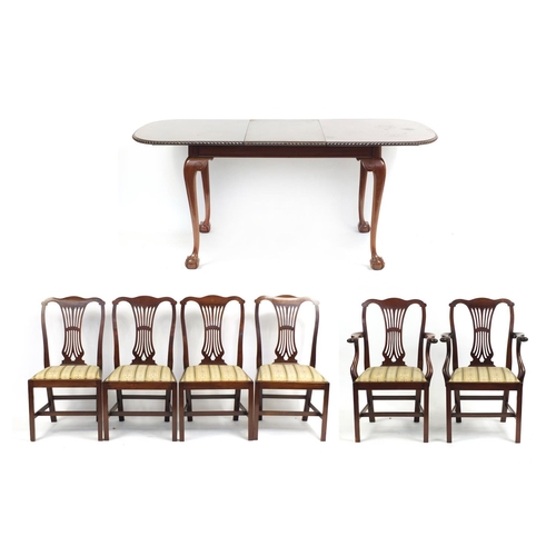 2184 - Mahogany extending dining table raised on ball and claw feet and extra leaf, together with a set of ... 