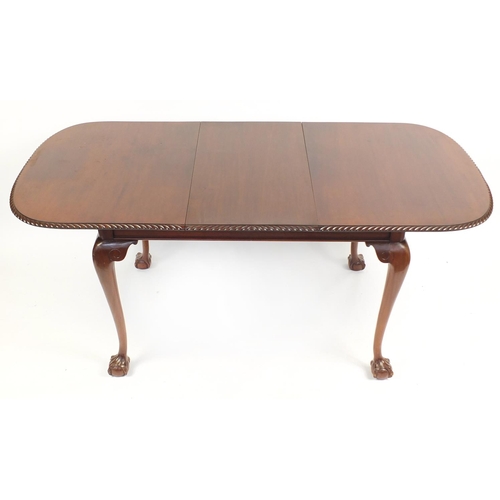 2184 - Mahogany extending dining table raised on ball and claw feet and extra leaf, together with a set of ... 