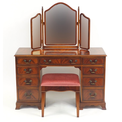 2177 - Mahogany dressing table with footstool and a folding triple aspect mirror, the dressing table 77cm H... 