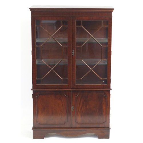 2196 - Mahogany display cabinet fitted with a pair of glazed doors enclosing two glass shelves above a pair... 