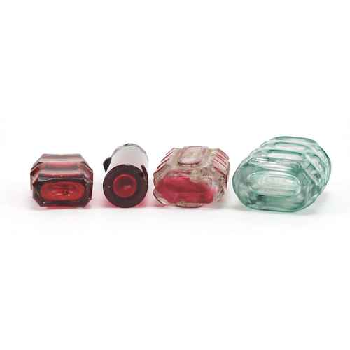 281 - Four Victorian glass scent bottles including a cranberry example with embossed silver lid, the large... 