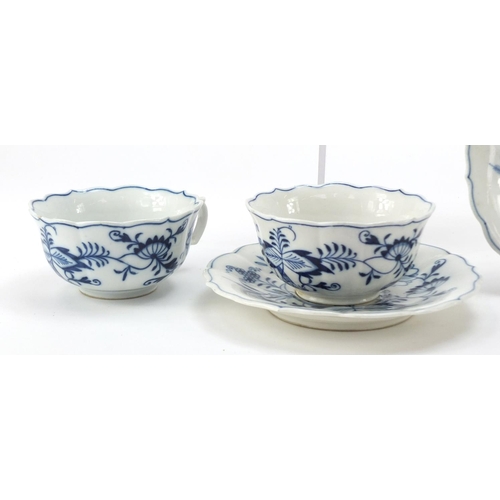 461 - Five Meissen fluted cups and saucers hand painted in the Blue Onion pattern, crossed sword marks to ... 