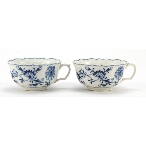 461 - Five Meissen fluted cups and saucers hand painted in the Blue Onion pattern, crossed sword marks to ... 