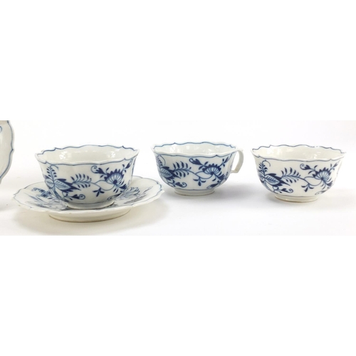 461 - Five Meissen fluted cups and saucers hand painted in the Blue Onion pattern, crossed sword marks to ... 