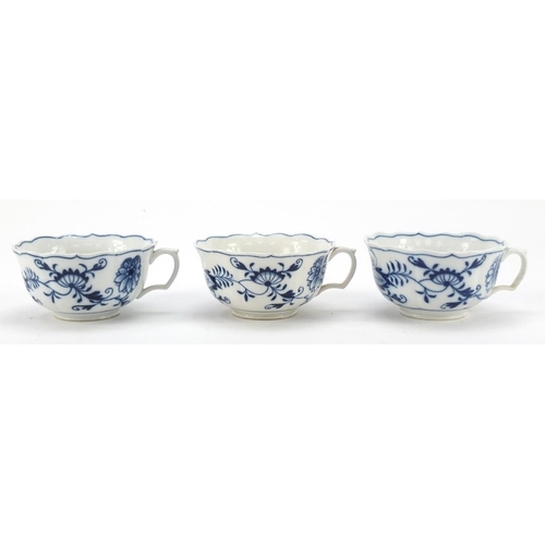 461 - Five Meissen fluted cups and saucers hand painted in the Blue Onion pattern, crossed sword marks to ... 