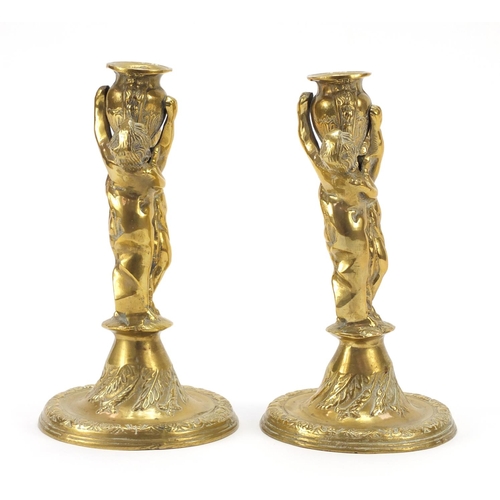 115 - Pair of classical bronzed candlesticks with Putti columns, each 24cm high