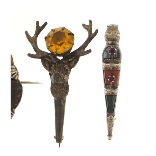 366 - Three Scottish hardstone brooches including a silver dirk, the largest 4.5cm in diameter