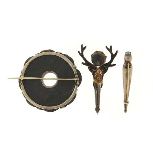 366 - Three Scottish hardstone brooches including a silver dirk, the largest 4.5cm in diameter