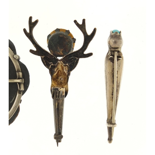 366 - Three Scottish hardstone brooches including a silver dirk, the largest 4.5cm in diameter