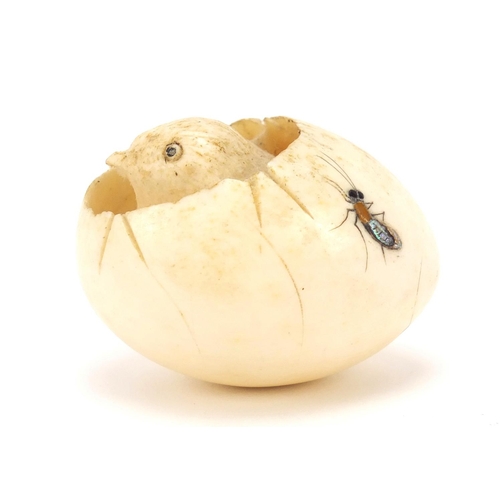 75 - Japanese Shibayama carved ivory chick hatching from an egg, inlaid with insects, 5cm wide