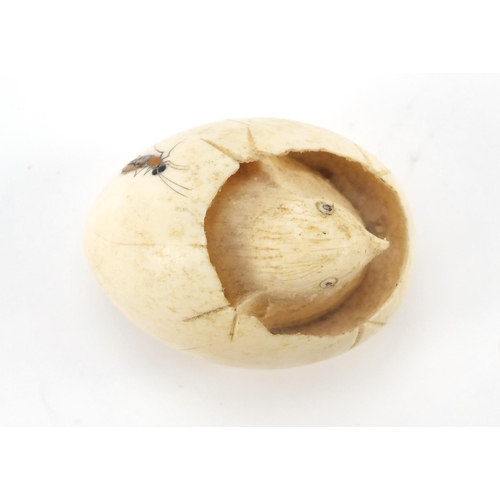 75 - Japanese Shibayama carved ivory chick hatching from an egg, inlaid with insects, 5cm wide