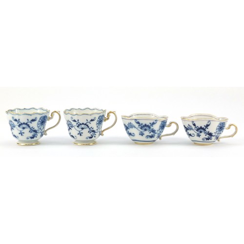 94 - Meissen porcelain hand painted in the blue onion pattern comprising two fluted cups with saucers, tw... 