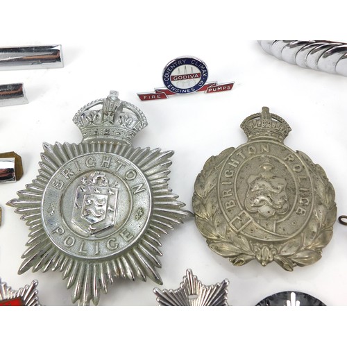 602 - Collection of vintage and later fire and police badges, pips and helmet plates