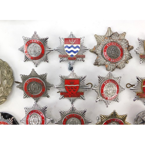 602 - Collection of vintage and later fire and police badges, pips and helmet plates