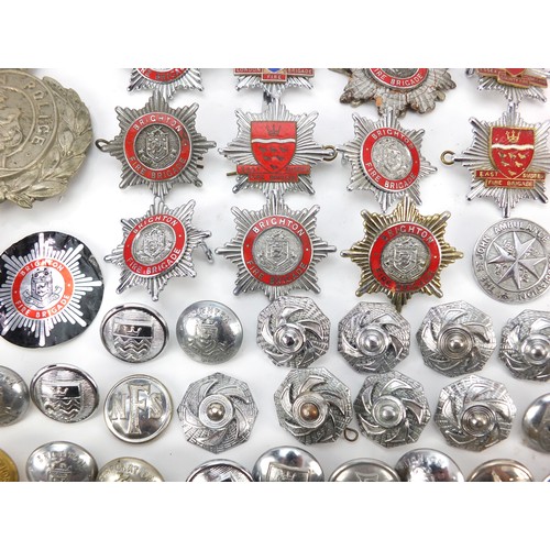 602 - Collection of vintage and later fire and police badges, pips and helmet plates