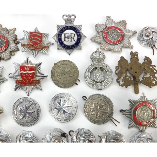 602 - Collection of vintage and later fire and police badges, pips and helmet plates