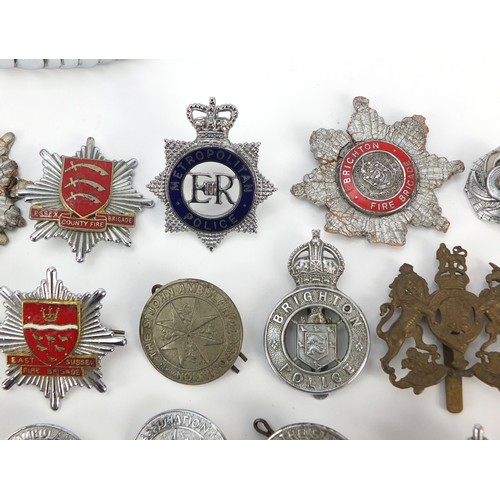 602 - Collection of vintage and later fire and police badges, pips and helmet plates