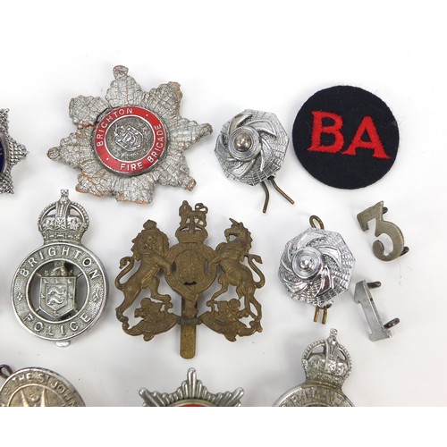 602 - Collection of vintage and later fire and police badges, pips and helmet plates