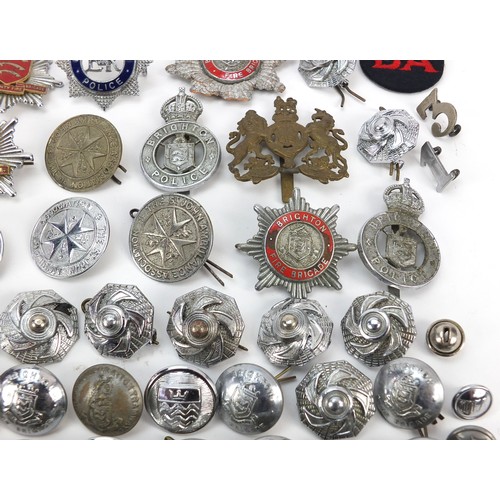 602 - Collection of vintage and later fire and police badges, pips and helmet plates