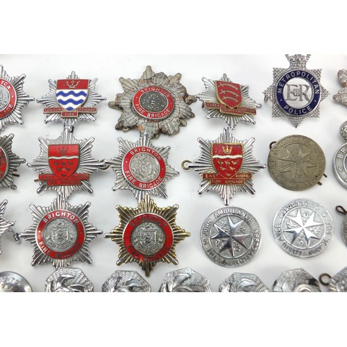 602 - Collection of vintage and later fire and police badges, pips and helmet plates