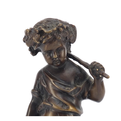 335 - Patinated bronze figure of a young figure gathering grapes, titled La Vendange, raised on an oval bl... 