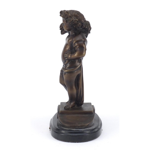 334 - Patinated bronze figure carrying wheat, titled La Misson, raised on an oval black marble base, 25cm ... 