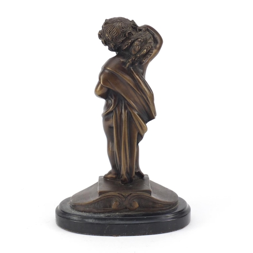 334 - Patinated bronze figure carrying wheat, titled La Misson, raised on an oval black marble base, 25cm ... 