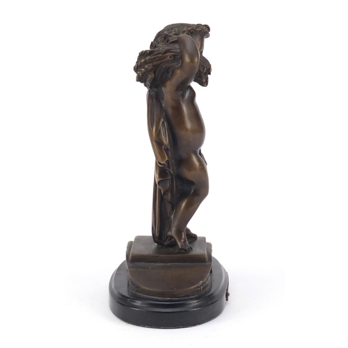 334 - Patinated bronze figure carrying wheat, titled La Misson, raised on an oval black marble base, 25cm ... 